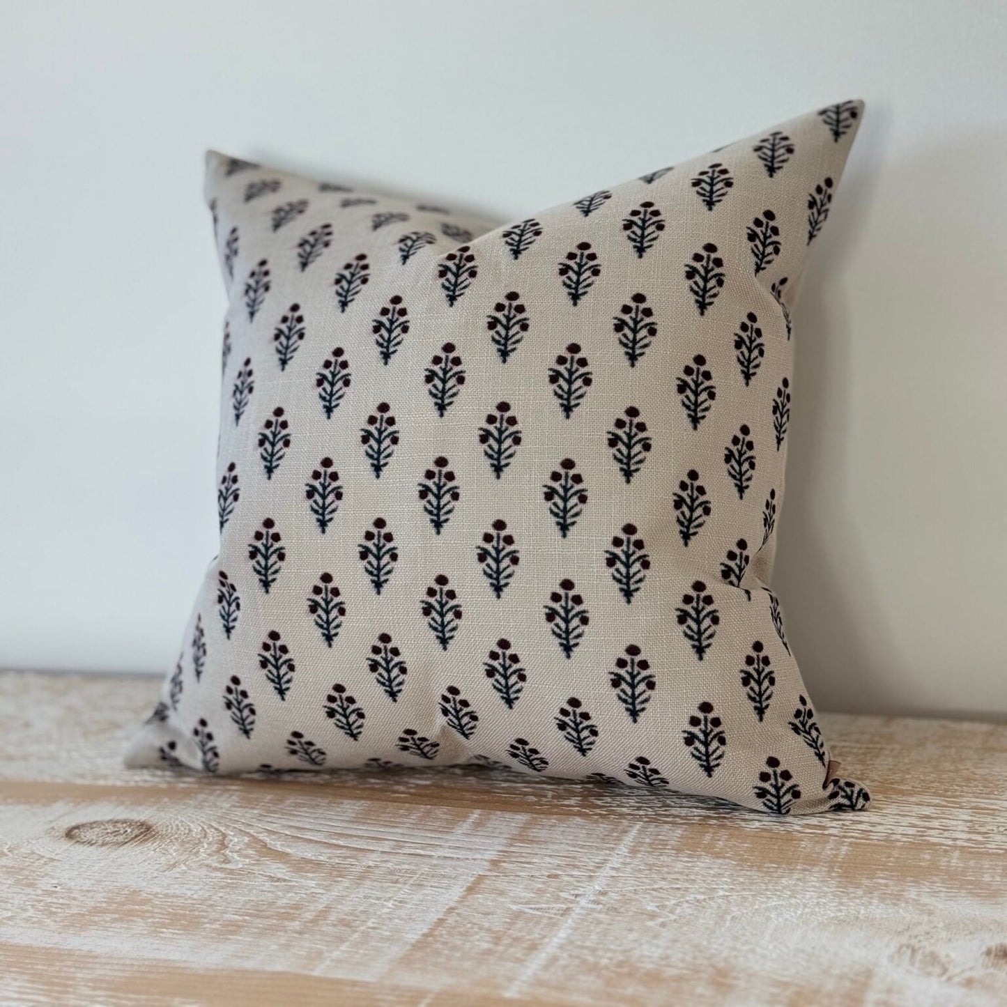 Decorative pillow with black pattern on a neutral background