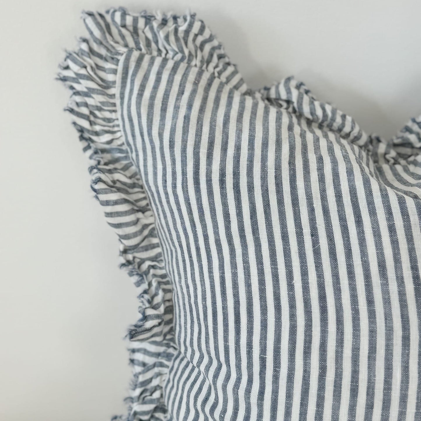 Striped fabric with ruffled edges on a plain background