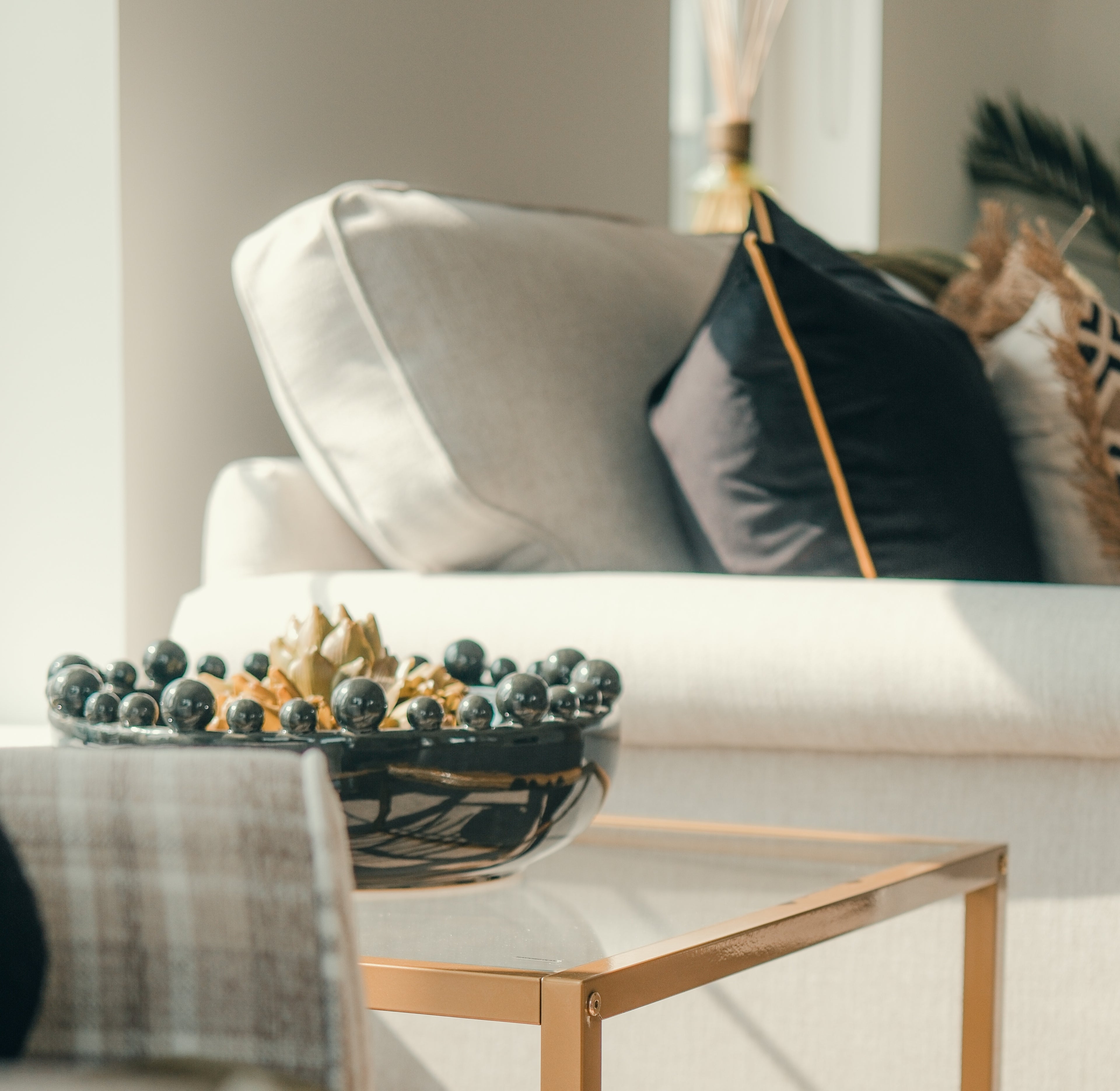 Decorative bowl with Green Faux Artichoke Head on a coffee table in a living room setting